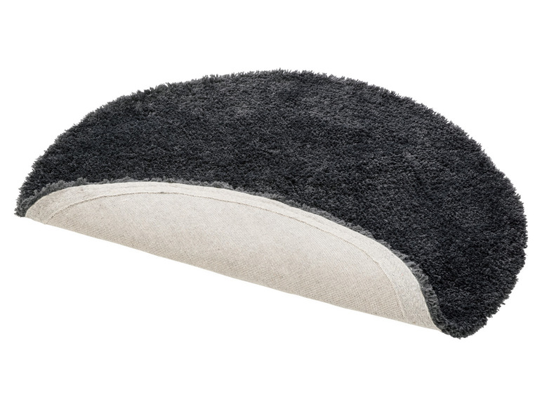 Un tapis rond gris avec une bordure beige.