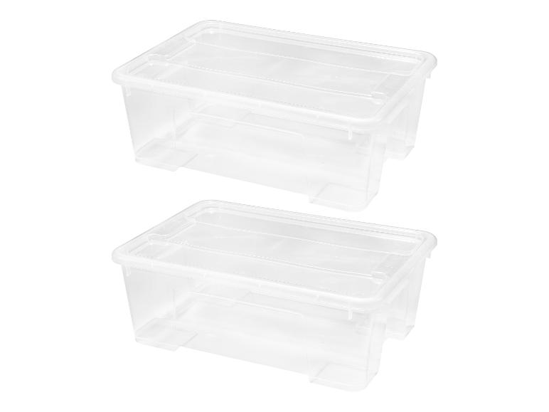 Deux boîtes de rangement en plastique transparent avec couvercles.