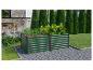 Ensemble de jardinières surélevées vertes avec légumes, à côté d'un coin repas extérieur.