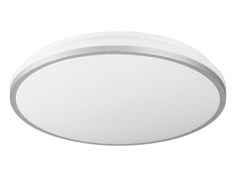 Un luminaire de plafond rond avec une bordure argentée.