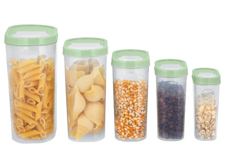 Cinq récipients transparents avec couvercles verts, remplis de pâtes, maïs, café et avoine.
