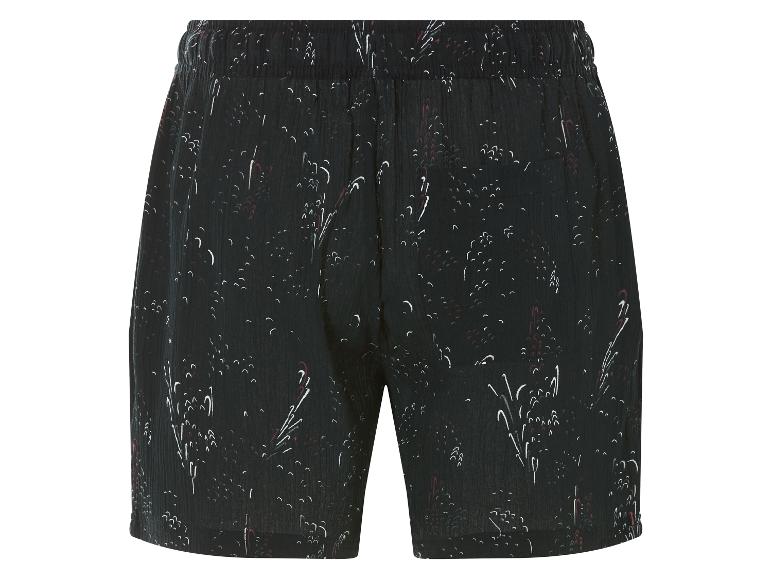 Shorts noirs à motif floral stylisé.