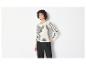 Une femme porte un pull blanc à rayures et un pantalon noir.