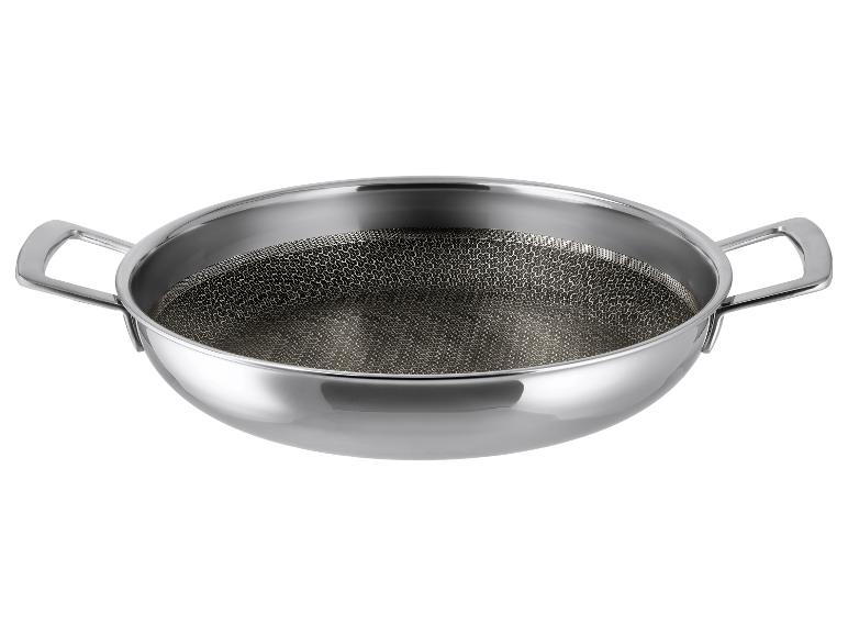 Wok en acier inoxydable avec double poignée et base à motif nid d'abeille.
