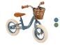 Une draisienne bleue Huffy avec un panier.
