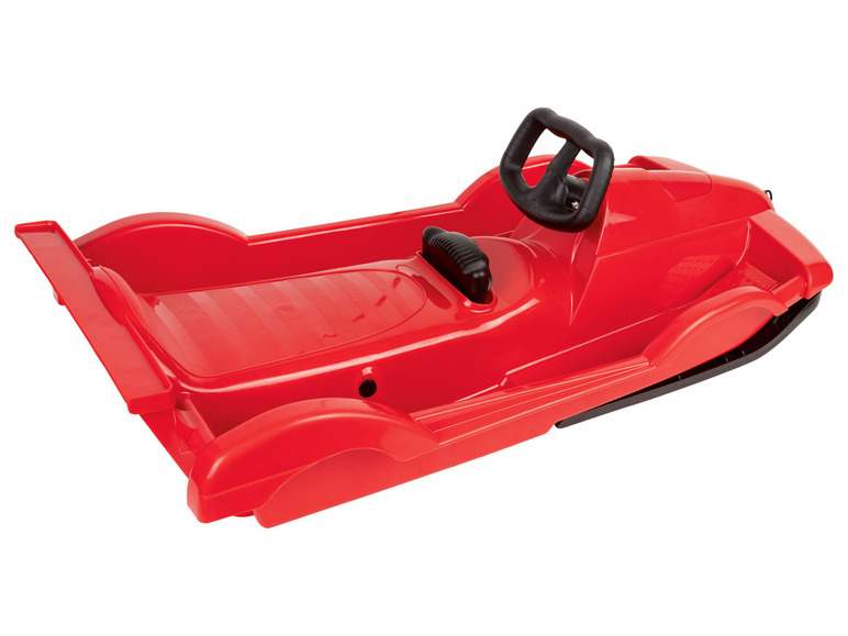 Une luge en plastique rouge avec un volant.