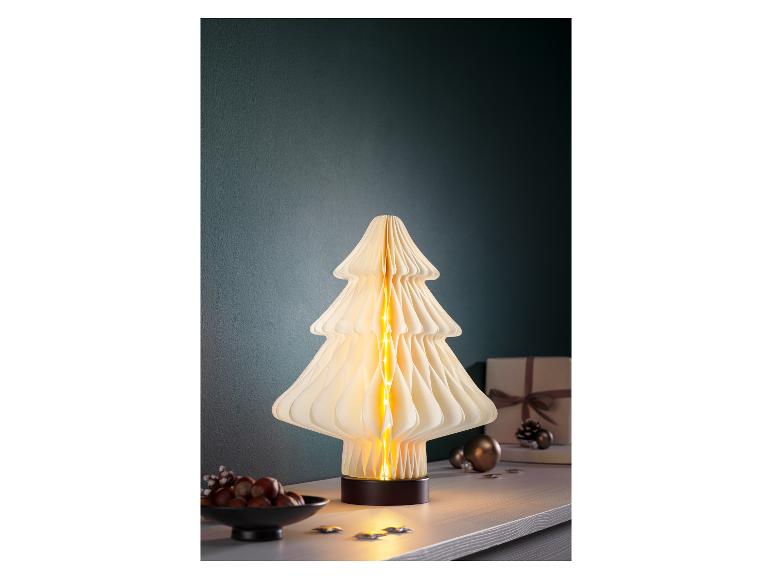 Lampe décorative en forme de sapin de Noël avec des lumières chaudes sur une table.