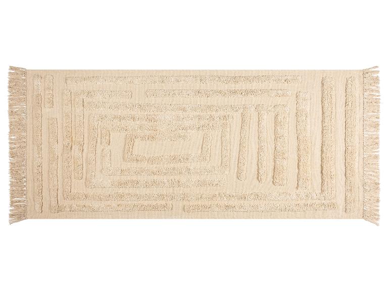 Tapis rectangulaire beige avec un motif géométrique en relief et des franges.