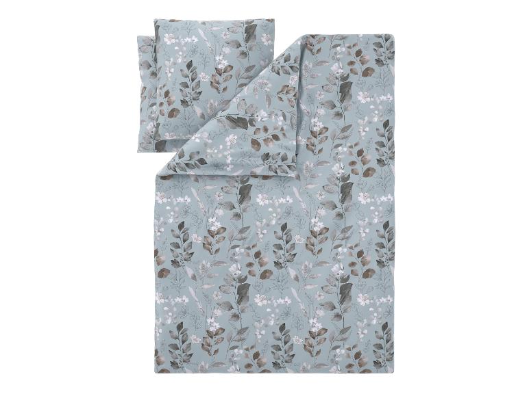 Parure de lit avec motif feuilles et fleurs sur fond bleu.