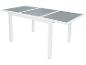 Table extensible blanche avec plateau en verre gris.