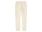 Pantalon de survêtement crème avec ceinture élastique.