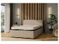 Un lit beige avec un matelas et un mur en bois.