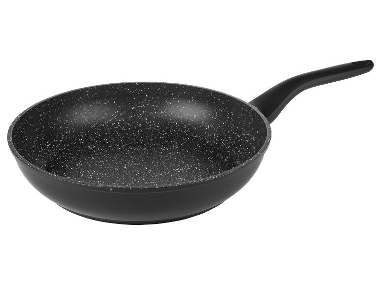 Poêle à frire antiadhésive noire avec manche, intérieur moucheté de blanc.