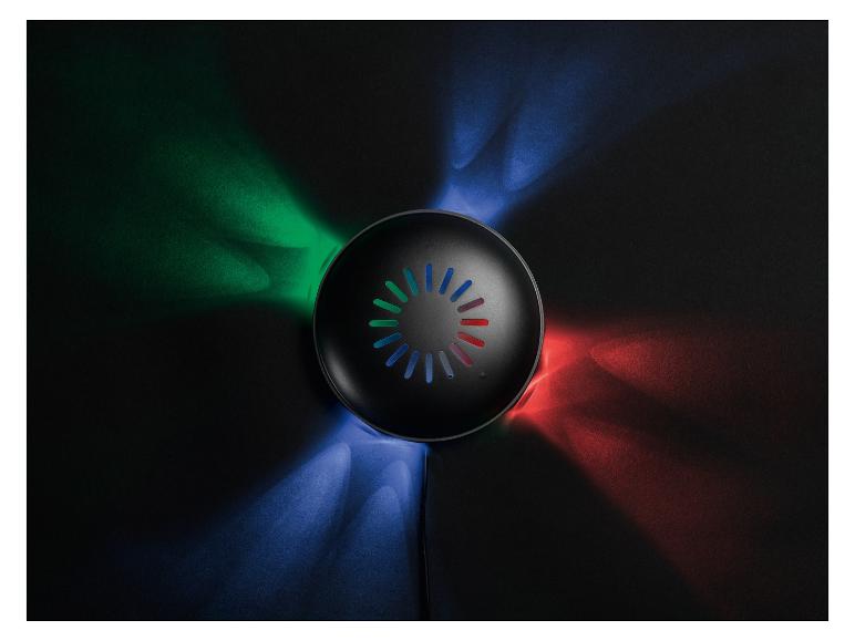 Enceinte ronde noire avec lumières RGB sur fond sombre.