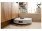 Robot aspirateur nettoyant le sol sous un meuble en bois.