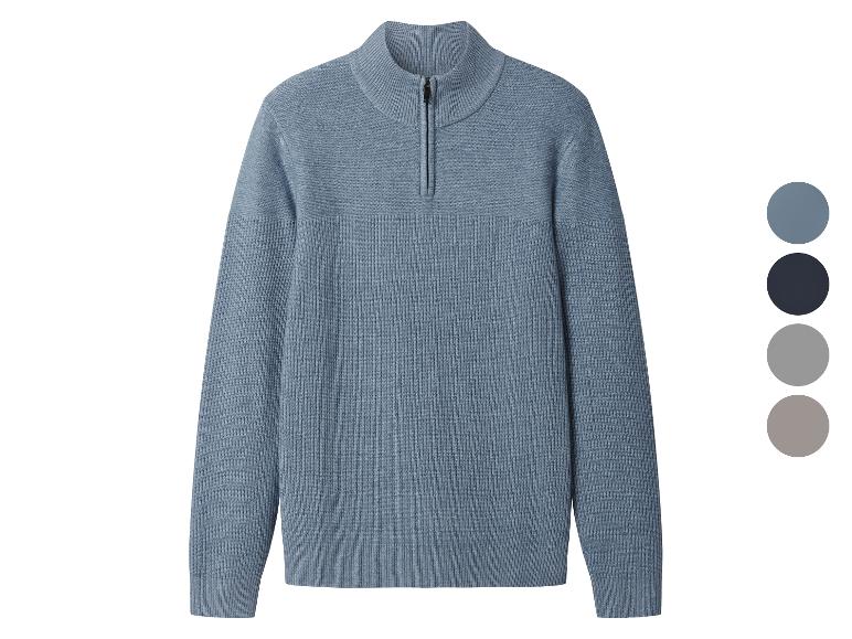 Pull en tricot bleu avec fermeture éclair courte et palette de couleurs.