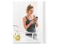 Femme en tenue de sport utilisant un smartphone dans une cuisine avec des fruits et de l'eau.