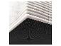 Détail d'un filtre à air blanc avec une section inférieure noire perforée.
