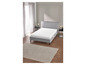 Un lit gris avec un matelas blanc dans une chambre moderne.