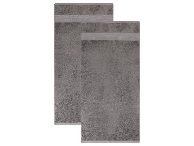 Deux serviettes de bain grises avec des bandes décoratives