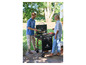 Un homme et une femme font griller des hamburgers sur un barbecue à gaz Grillmeister.