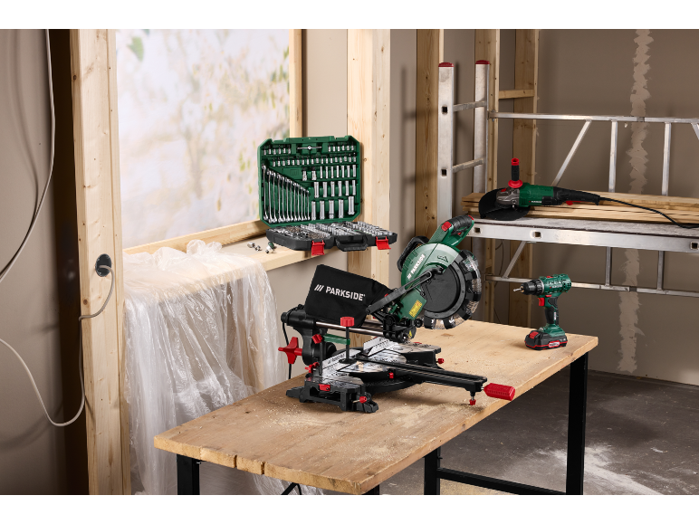 Scie à onglet, kit d'outils, meuleuse d'angle et perceuse sur un chantier.