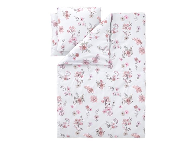 Parure de lit avec housse de couette et taie d'oreiller à motif floral rose et blanc.