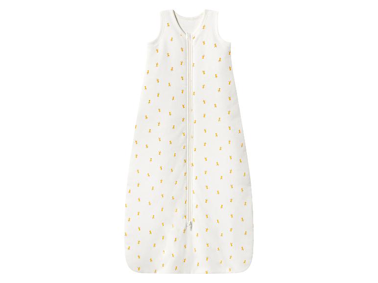 Gigoteuse blanche pour bébé avec de petits motifs de canards jaunes et une fermeture éclair frontale