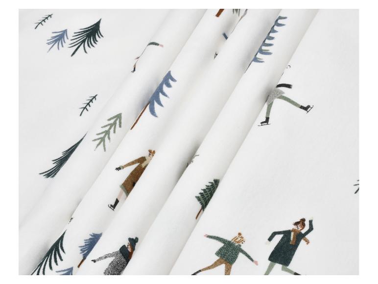 Tissu blanc avec un imprimé de sapins et de personnes patinant