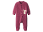Une grenouillère rose pour bébé avec un motif de lapin.
