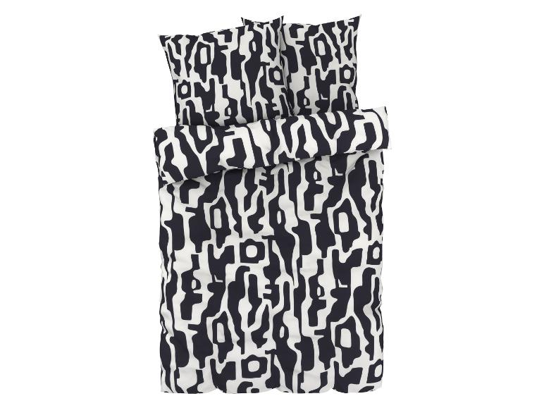 Une parure de lit avec un motif abstrait noir et blanc.