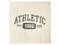 Texte brodé 'ATHLETIC 1986' sur fond beige.