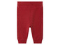 Pantalon rouge avec des côtés côtelés.