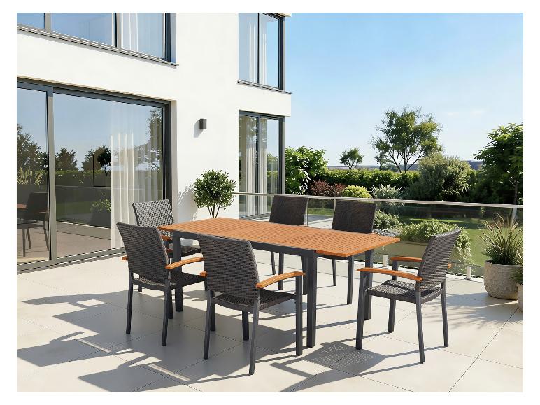 Ensemble de salle à manger de jardin avec table en bois et six chaises sur une terrasse.