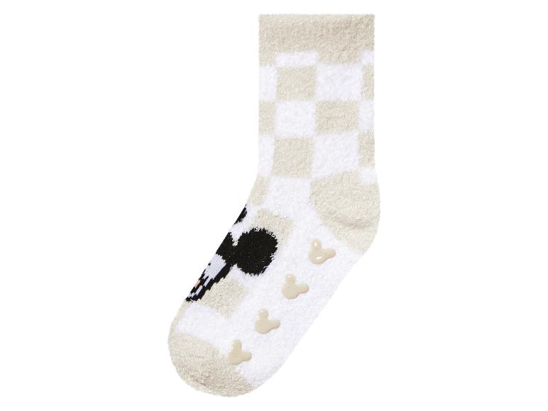 Des chaussettes blanches et beiges avec un motif Mickey Mouse et à carreaux.