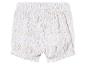 Shorts bébé, motif floral beige clair sur fond blanc.
