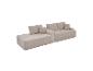 Canapé modulaire en velours côtelé beige avec coussins.