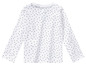 T-shirt blanc à manches longues avec un motif de cœurs.