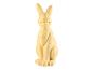 Une figurine de lapin jaune assise.
