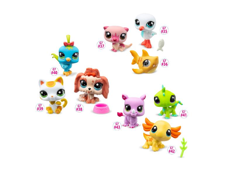 Une collection de figurines colorées Littlest Pet Shop, incluant un oiseau, un chat, un chien et d'autres animaux.