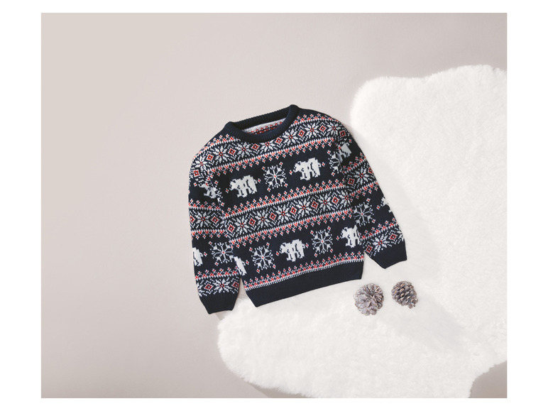 Pull de Noël avec des rennes et des flocons de neige.