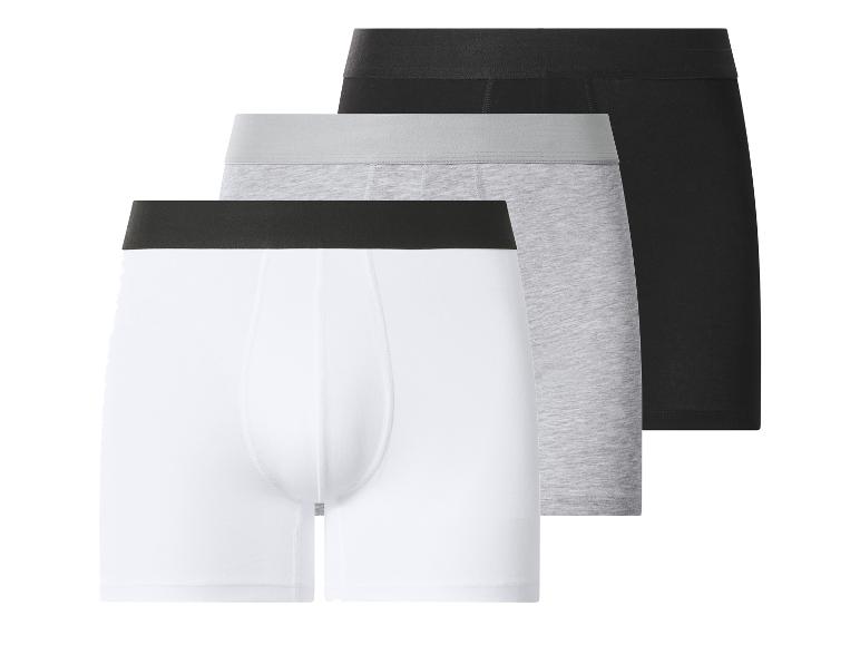 Trois boxers pour hommes : blanc, gris et noir.