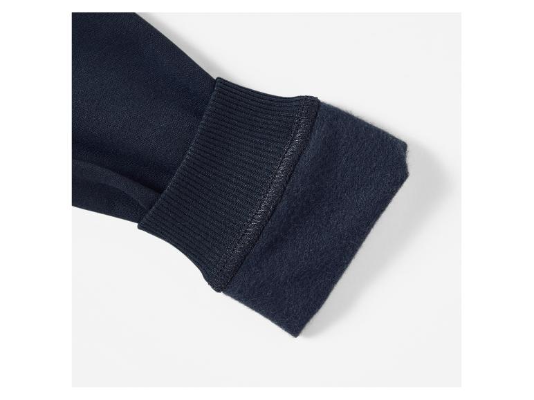 Détail d'un pull bleu foncé avec une doublure en polaire douce.