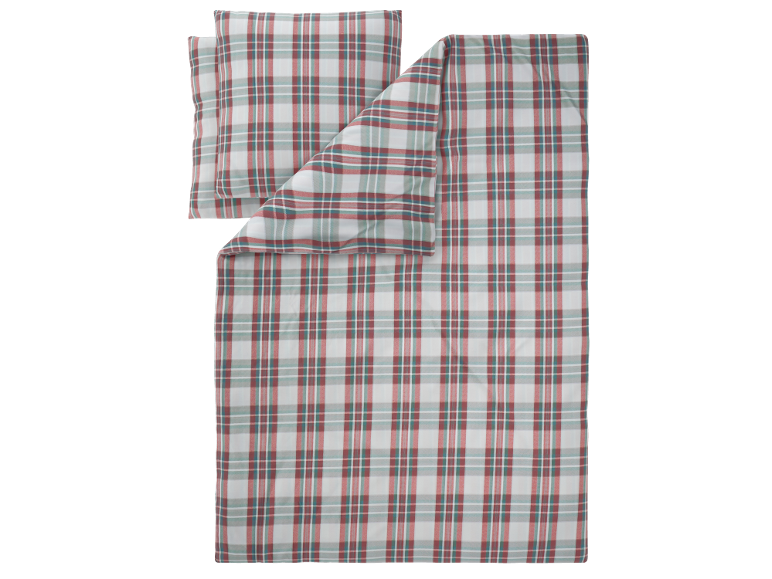 Plaid et oreiller à motif écossais rouge et vert.