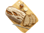 Pain avec tranches, confiture et beurre sur une planche en bois.