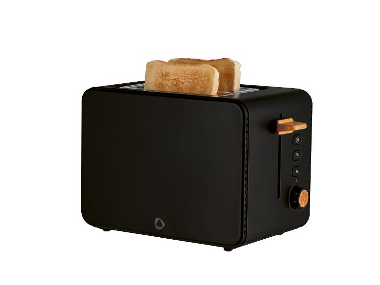 Grille-pain noir avec deux tranches de pain et des accents en bois