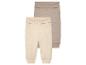 Deux leggings bébé, beige et taupe, en tissu doux.