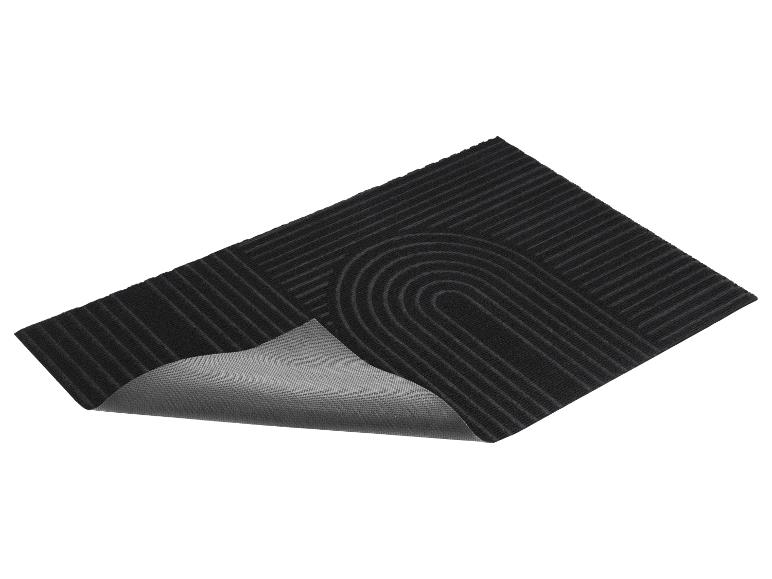 Paillasson noir avec motif rayé et bord arrondi.