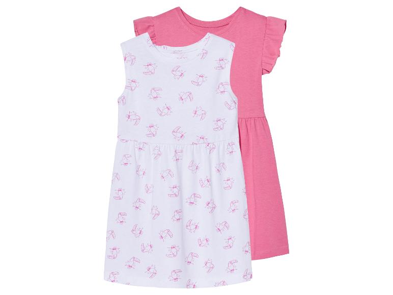 Deux robes pour filles : une à imprimé toucans roses et une rose unie.