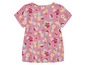 Un t-shirt rose à imprimé de fruits tropicaux